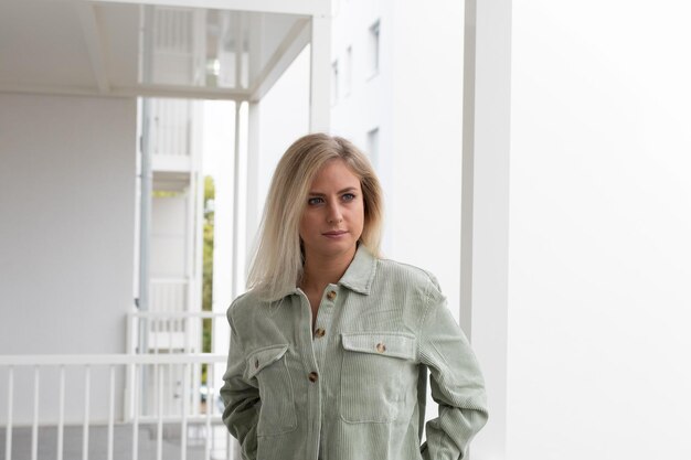 young woman standing against wall