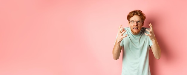 Young woman standing against yellow background