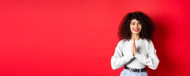 写真 黄色い背景に立っている若い女性