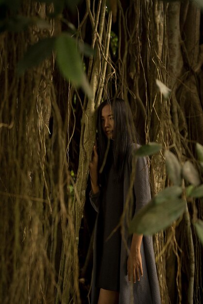 Young woman standing amidst plants