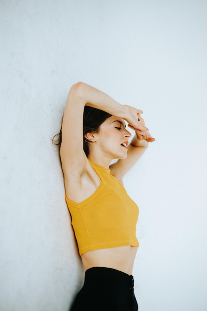young woman standing by white background