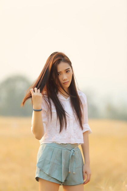 Young woman standing on field