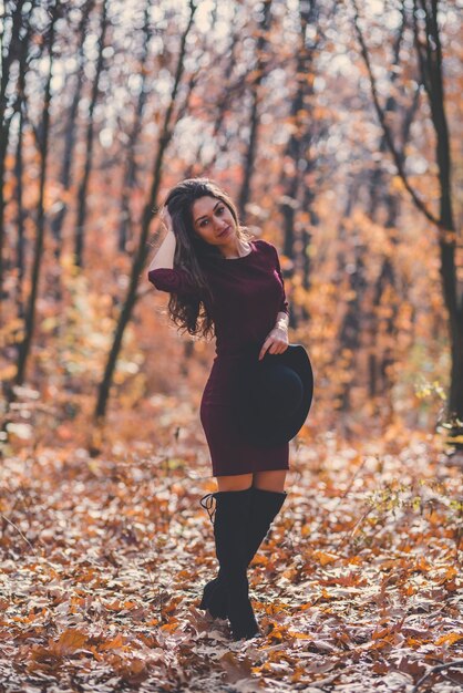 Photo young woman standing in forest during autumn