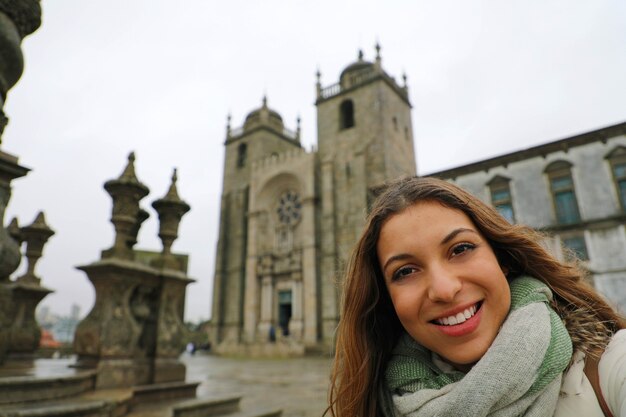 Young woman standing in front of Porto Cathedral