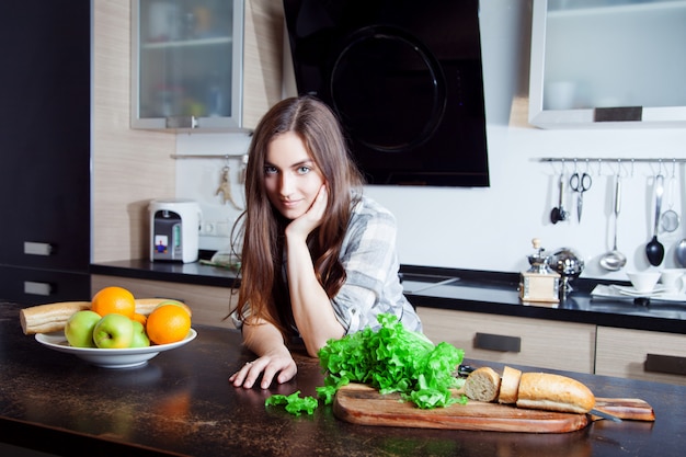 Young woman standing in a kitchen