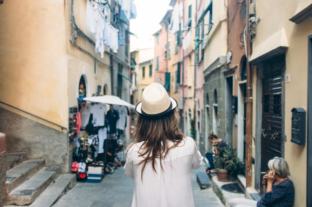 Young woman standing on narrow town street