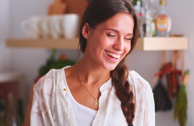 Young woman standing near desk in the kitchen Young woman