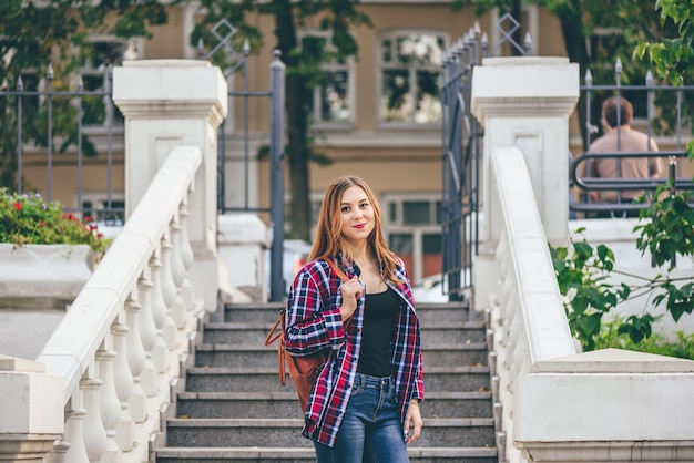 Young woman standing on the old staircase