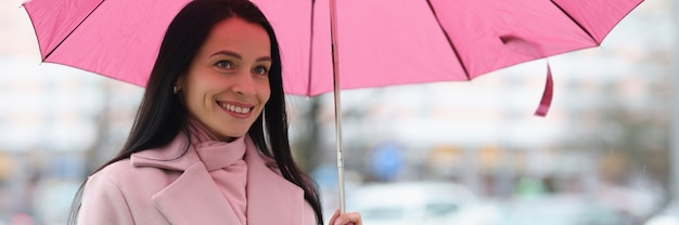 Молодая женщина, стоящая под дождем с зонтиком в руках концепция прогноза погоды