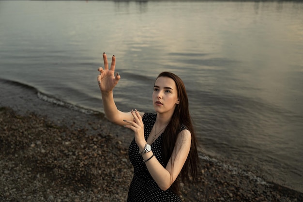 Young woman standing on shore at beach