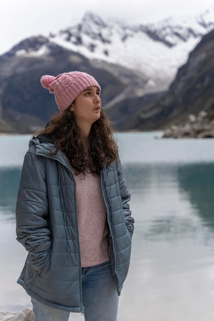 Young woman standing while gazing at a picturesque landscape with a lake