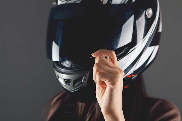 Young woman standing with motorcycle helmet