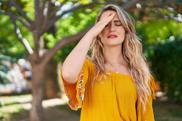 Young woman standing worried expression at park