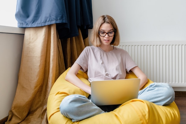 Young woman staring at laptop working online