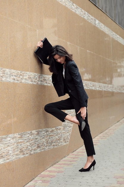 Young woman stopped to check her heels