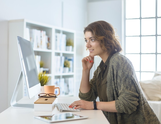 Young woman or student using tablet computer at home