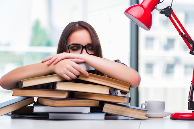 Young woman student with many books