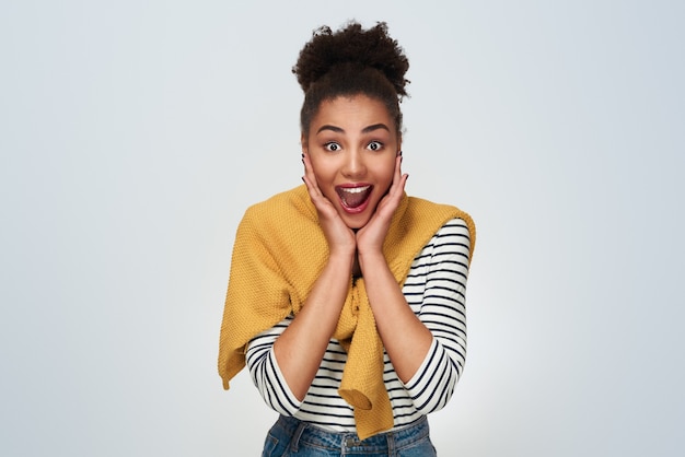 Young woman studio isolated in white looking camera excited