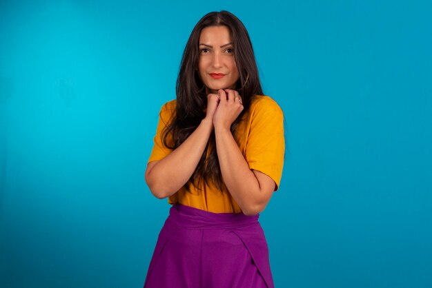 Young woman in studio photo and in colorful clothes