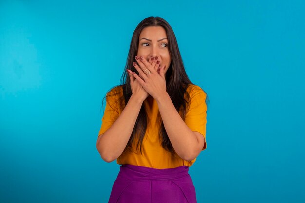 Young woman in studio photo and in colorful clothes