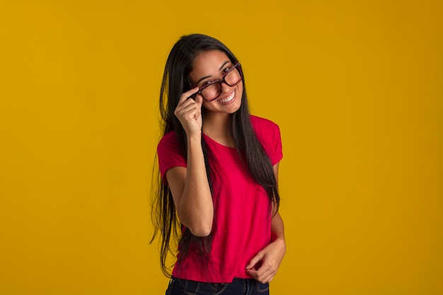 Young woman in studio photo wearing shirt and glasses