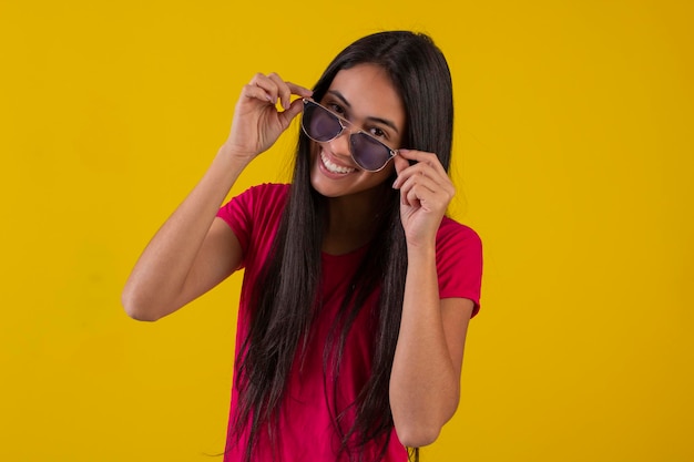 Young woman in studio photo wearing shirt and glasses