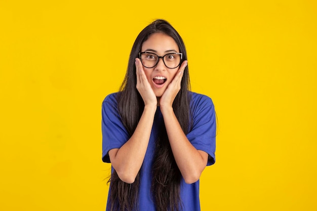 Young woman in studio photo wearing shirt and glasses