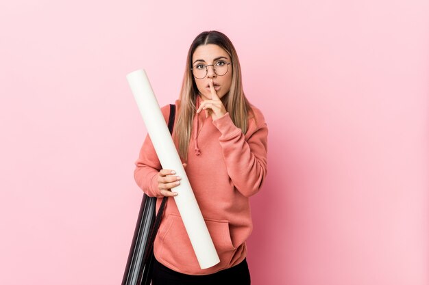 Young woman studying architecture keeping a secret or asking for silence.