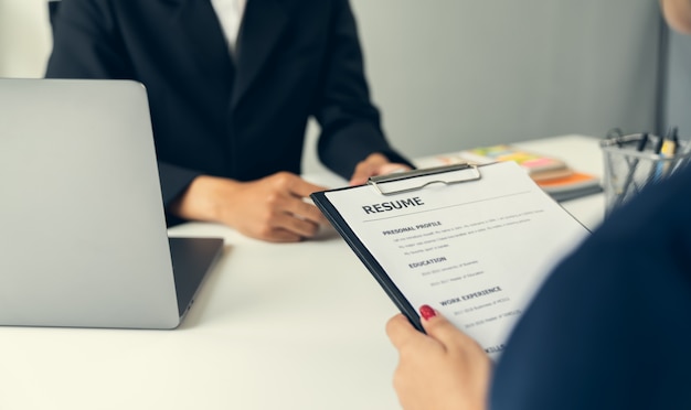 Young woman submit resume for a job interview in office. Quality employment concepts.