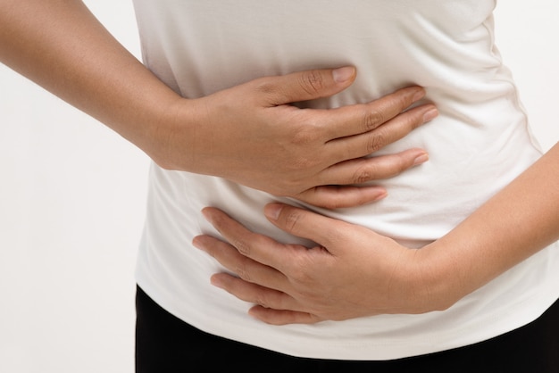 Young woman suffering from abdominal pain feeling stomach ache, symptom of pms 