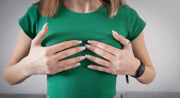 Young woman suffering from breast pain.