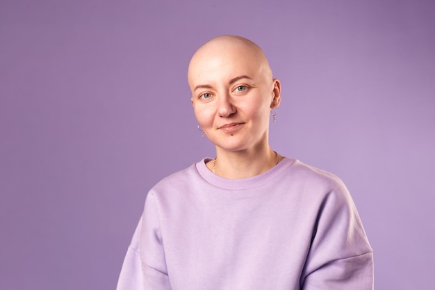 Young woman suffering from cancer laugh smile feel positive about future recovery Millennial female with shaved head