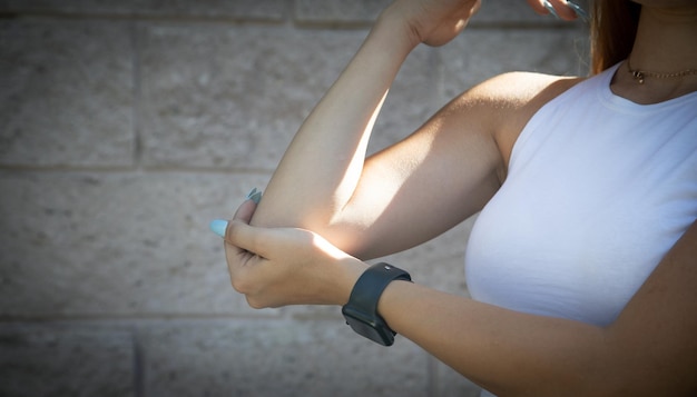 Young woman suffering from elbow pain