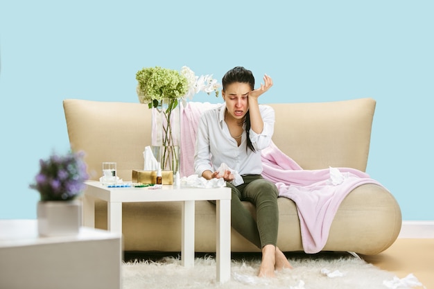 Young woman suffering from hausehold dust or seasonal allergy.