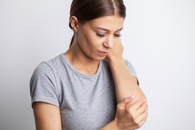 Young woman suffering pain on hands and fingers