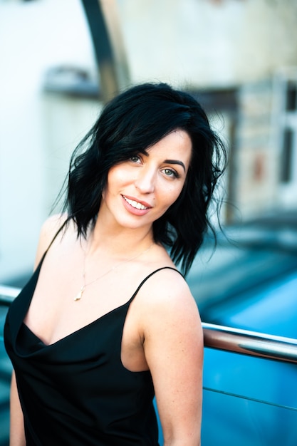 young woman in summer in a  black dress