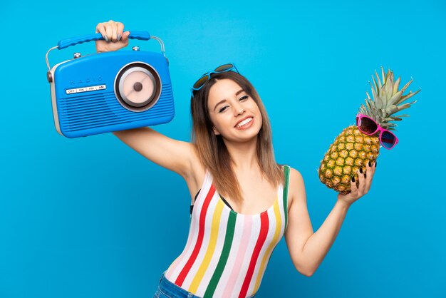 Young woman in summer holidays over blue 