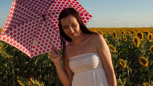 Young woman in sunflower field.