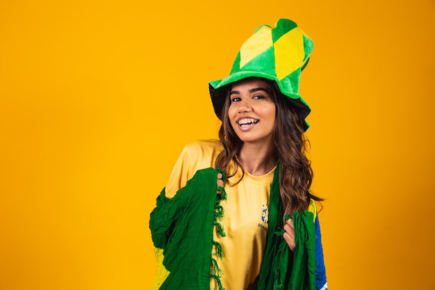 Young woman supporter from Brazil with flag and dressed for the game.