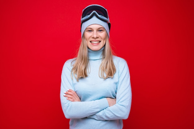 A young woman in a sweater and ski goggles