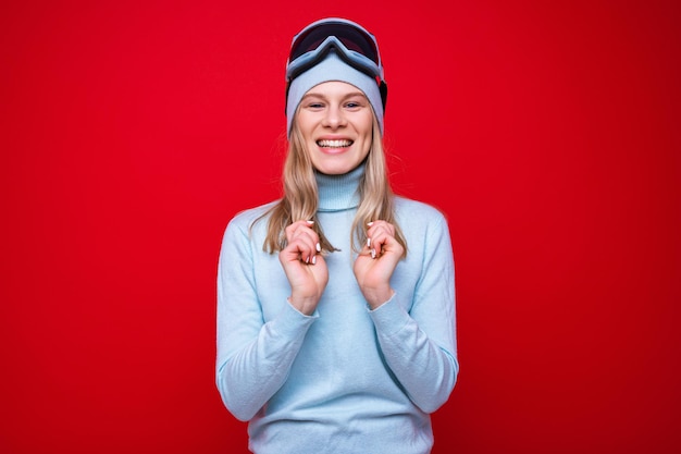 A young woman in a sweater and ski goggles