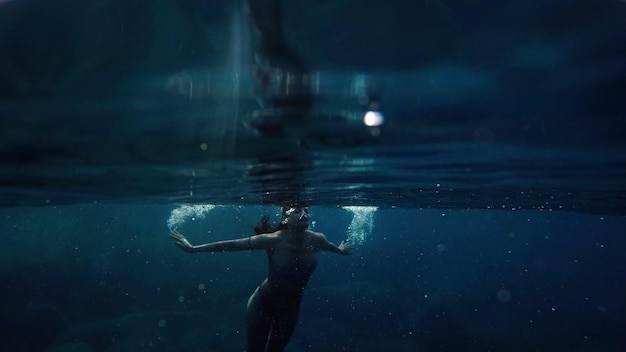 young woman swimming undersea