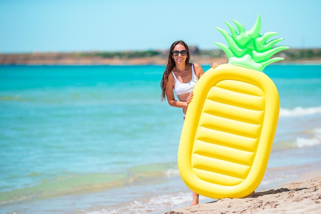 Young woman in swimsuit on the beach vacation ready to swim