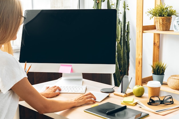 Young woman and tablet working at home office.