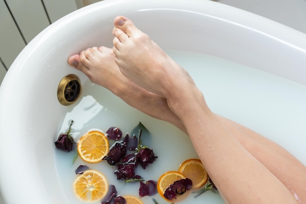 A young woman takes a bath and takes care of her skin