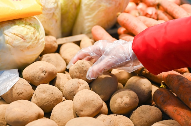 Young woman takes vegetables in the store