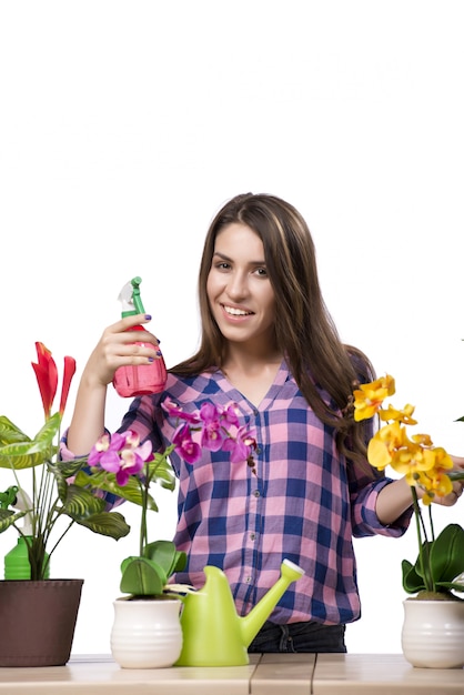 Young woman taking care of home plants