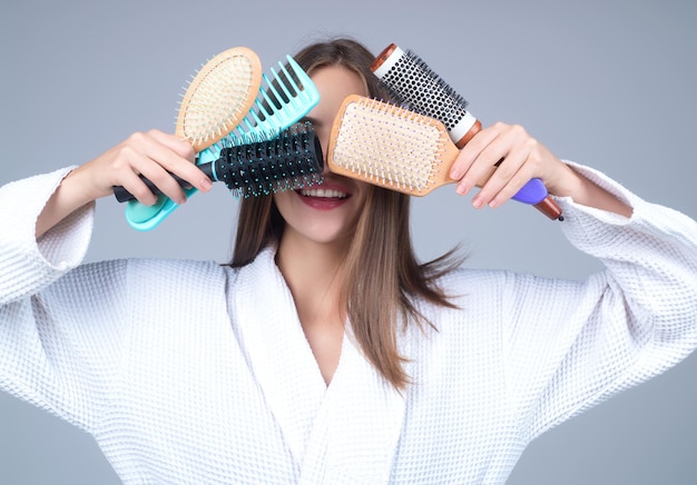 Young woman taking care with hair comb of her hair haircare pretty girl brushing hairs with comb bea