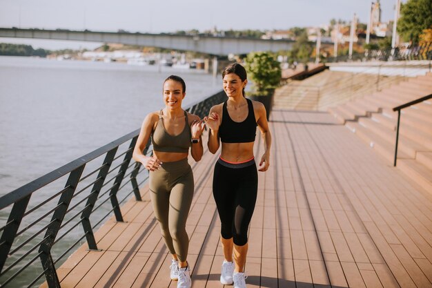 Young woman taking running exercise by the river promenade