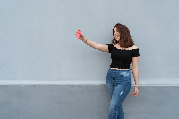 Young woman taking a selfie and smiling